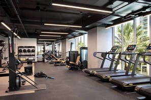 A gym with treadmills, weight machines, and exercise balls. - NEW Lux Condo - High-Floor Views · Gym · Pool · (Miami)
