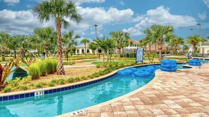 A swimming pool with a 3 ft depth marker, surrounded by palm trees and a tiled deck. - Mickey & Mario Luxury Retreat, private pool (Kissimmee)