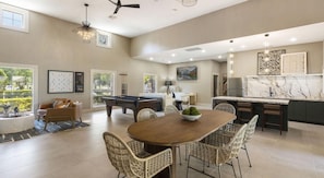 A spacious living area with a pool table, dining table, and chairs. - Landing | Beautiful 2BD, Gym, Clubhouse (Houston)