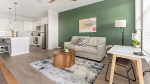 A modern living space with a kitchen, dining area, and seating area. - Landing | Incredible 1BD, Yoga Studio, Game Room (Punta Gorda)