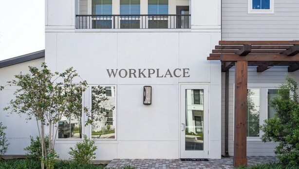 A building with a sign reading 'WORKPLACE' above the entrance, a wooden pergola to the right, and a small tree in front. - Landing | Stylish 2BD, Pool, Clubhouse (Port Charlotte)