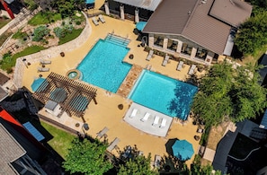 A rooftop swimming pool with sun loungers, a hot tub, and a covered seating area. - Landing | Stylish 2BD, Gym, Pool (Austin)