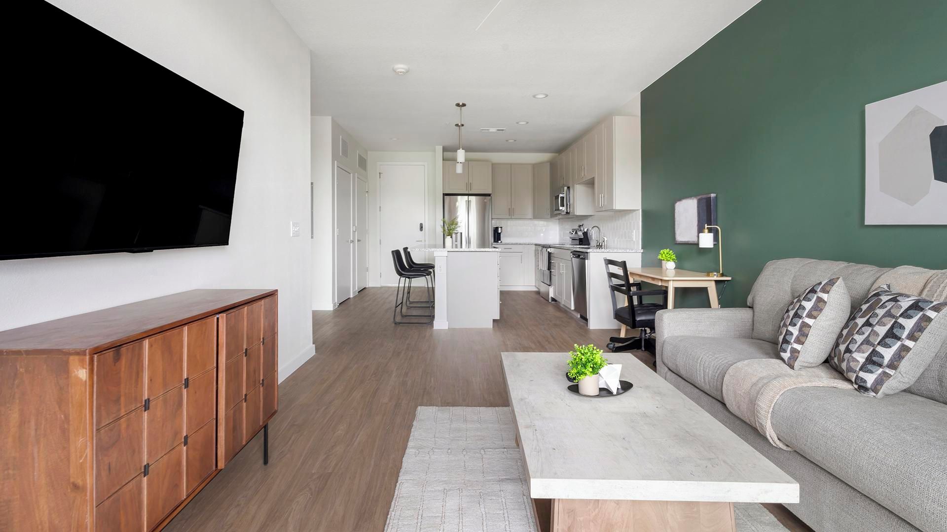 A modern apartment with a living room, kitchen, and dining area.