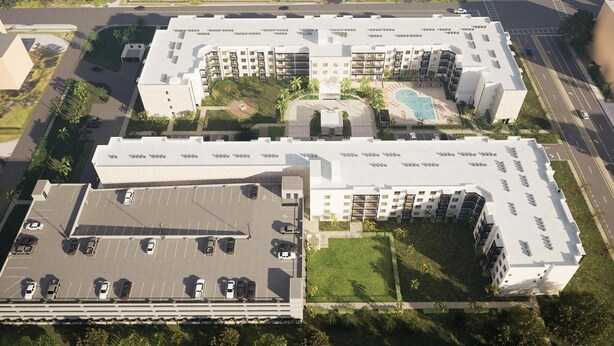 Un hotel de varios pisos con piscina en la azotea, estacionamiento y zonas ajardinadas.