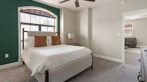 A bedroom with a bed, a nightstand, a lamp, and a ceiling fan. - Landing | Spectacular 2BD, Courtyard, Gym (San Antonio)