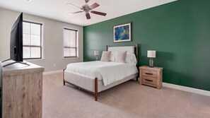 A bedroom with a bed, bedside tables, a ceiling fan, and a television. - Landing | Amazing 1BD, Courtyard, Gym (San Antonio)