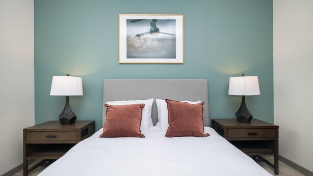 A neatly made bed with two pillows, a headboard, and two bedside tables with lamps. - Landing | Incredible 1BD in Kannapolis (Kannapolis)