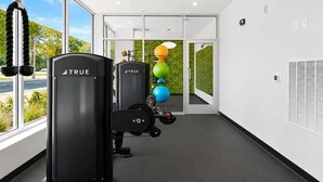 A gym with exercise equipment, large windows, and a view of the outdoors. - Landing | Stylish 1BD in Kannapolis (Kannapolis)