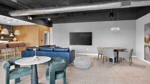 A modern interior with a sectional sofa, round tables, and a flat-screen TV. - Landing | Stunning 1BD in Kannapolis (Kannapolis)