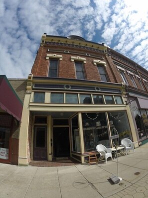 A two-story building with a large storefront and a visible entrance.