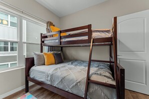 A bunk bed with a wooden frame, grey bedding, and multiple pillows. - Quiet Haven Amidst the Action! No Steps! - 3 Bed 2 Bath Condo (Branson)