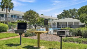 A courtyard with a pool, a barbecue grill, and a sign prohibiting pets. - Suite Y'all | 2-Min Walk to Beach | Pet Friendly (Santa Rosa Beach)
