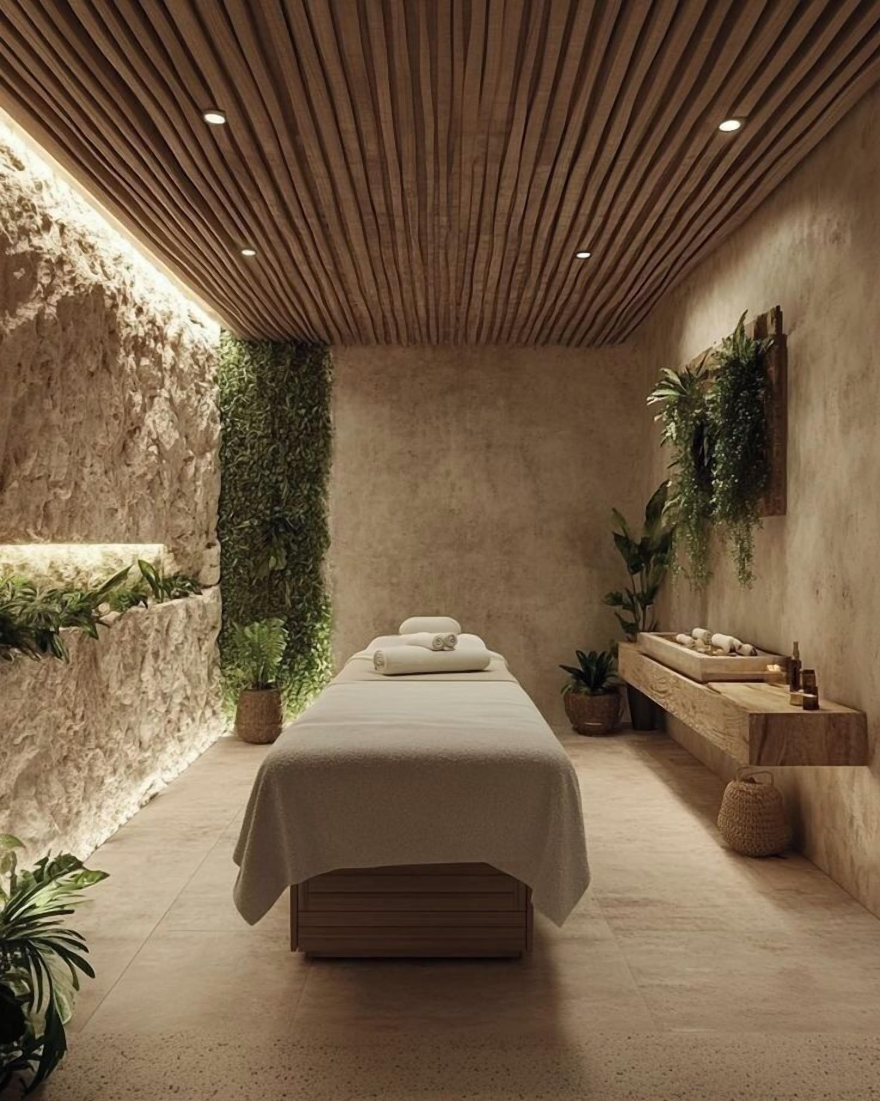 Un cuarto de spa con techo de madera, una cama, repisas con plantas y una pared de piedra.