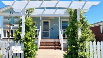 A house with a porch, a door, and a number '1007' on the wall.