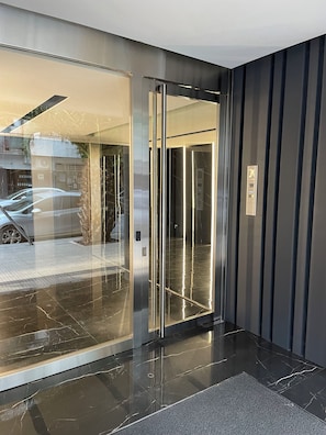 A modern elevator with a metallic finish and a digital control panel. - Premium Arcos Apartment. Modern. In the safest area of Buenos Aires. (Buenos Aires)