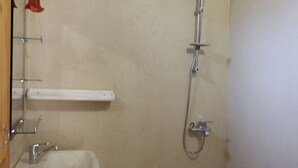 A bathroom with a sink, mirror, shower, and toilet. - Ferme Dar Charach (Tarmigt)