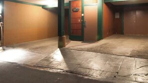 A parking garage with a single door, a concrete floor, and green-painted walls. - Beautiful 2-bedroom condo in quaint Incline Village perfect for relaxing (Incline Village)
