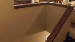 A staircase with a wooden handrail and a beige wall. - Beautiful 2-bedroom condo in quaint Incline Village perfect for relaxing (Incline Village)