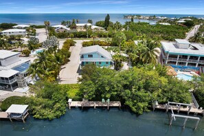 A coastal property with a pool, a dock, and a view of the ocean. - Sea Haven | A Charming Florida Keys Cottage Near Sombrero Beach (Marathon)