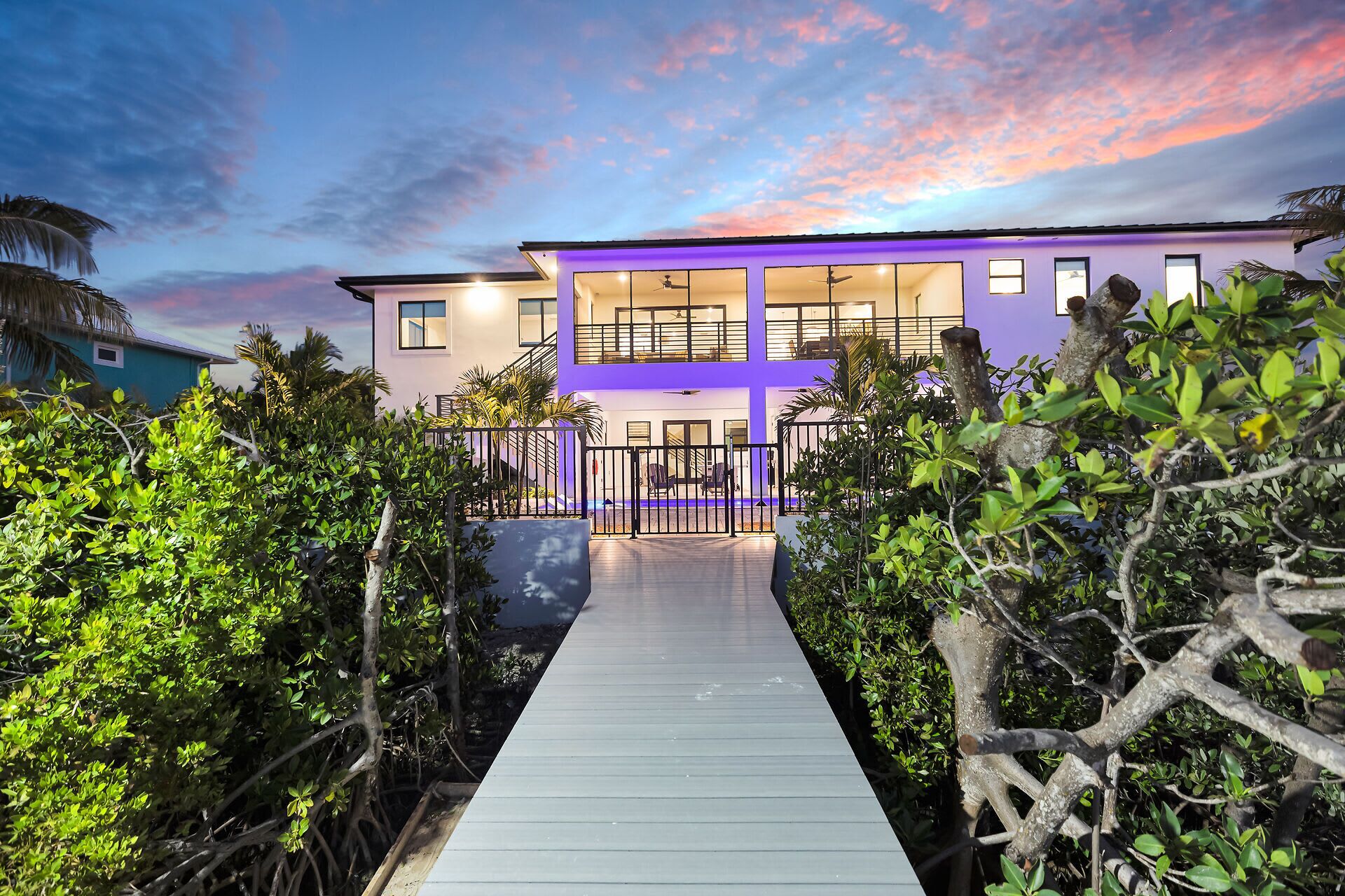 A modern two-story building with a covered walkway leading to the entrance.