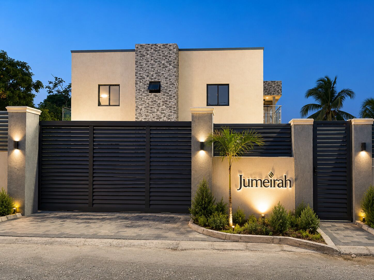 Un edificio moderno con entrada porticada, fachada de piedra y un cartel que dice 'Jumeirah'.