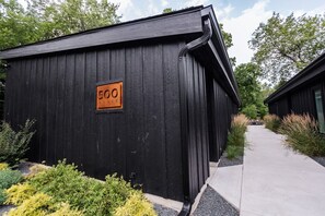 A black building with a sign reading '500 HOUSE' and a pathway leading to another building.
