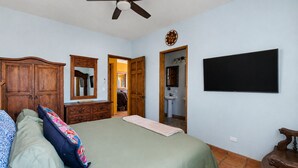 A bedroom with a bed, dresser, mirror, and a ceiling fan. - Beautiful Apartment with amazing views ! A hidden gem! (San José del Cabo)
