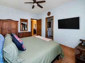 A bedroom with a bed, dresser, mirror, and a ceiling fan. - Beautiful Apartment with amazing views ! A hidden gem! (San José del Cabo)