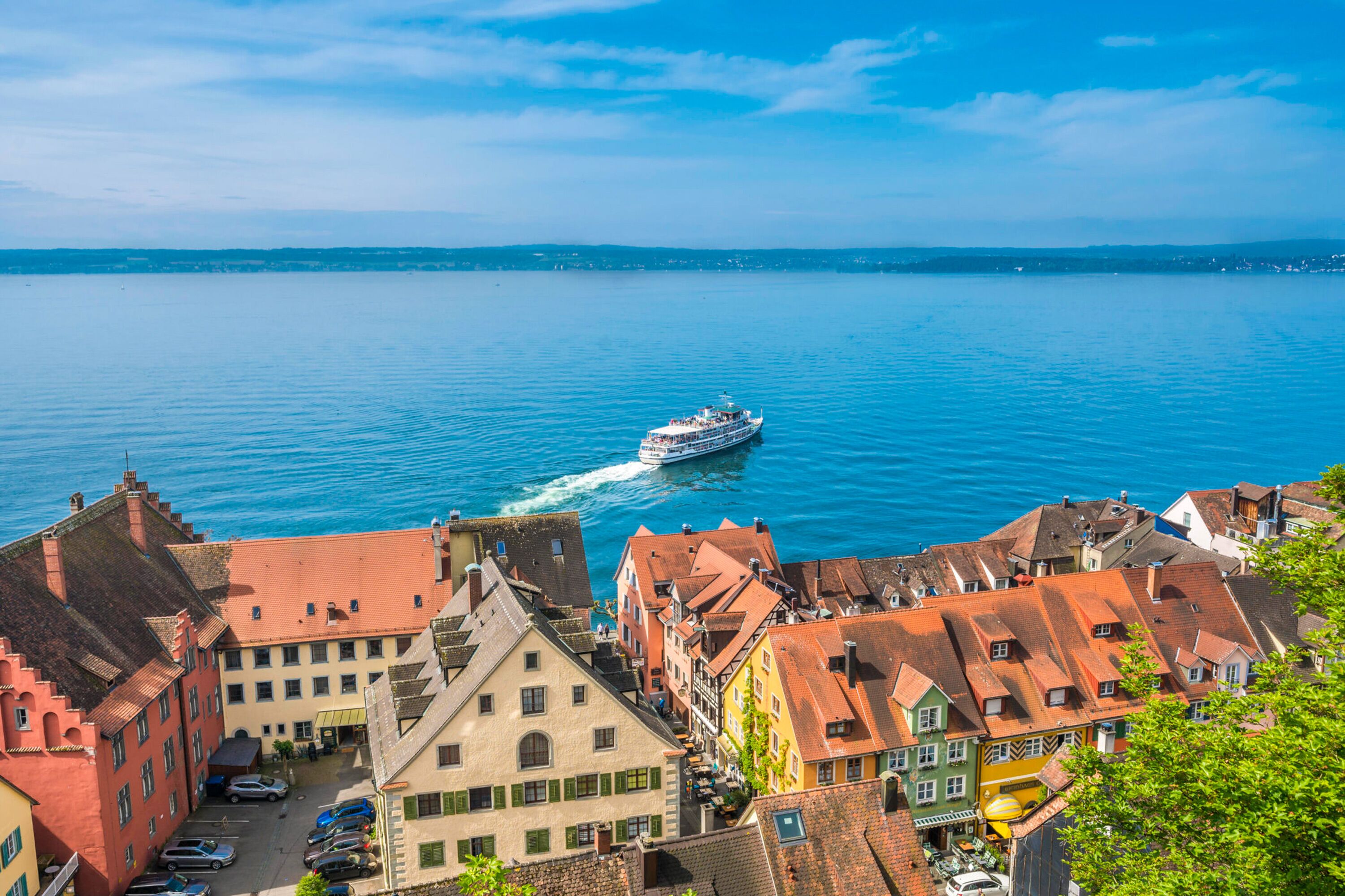 A waterfront view with traditional buildings and a boat on the water.