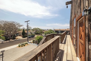 A wooden balcony with a view of a street and houses. - OldTown Barnhouse 1BR Historic OldTown & Dining (San Diego)