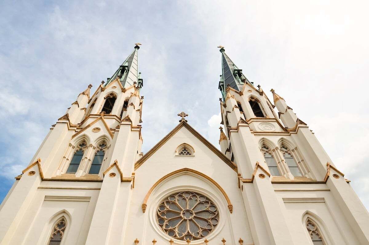 A church with two tall spires and a large circular window.