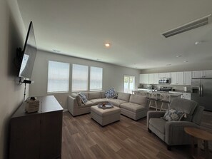 A modern living room with a sofa set, a coffee table, and a TV mounted on the wall. - Live Love Your North Myrtle Beach Vacation - North Myrtle Beach (North Myrtle Beach)