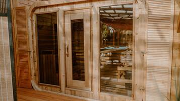 A wooden cabin with a large sliding glass door and a window.