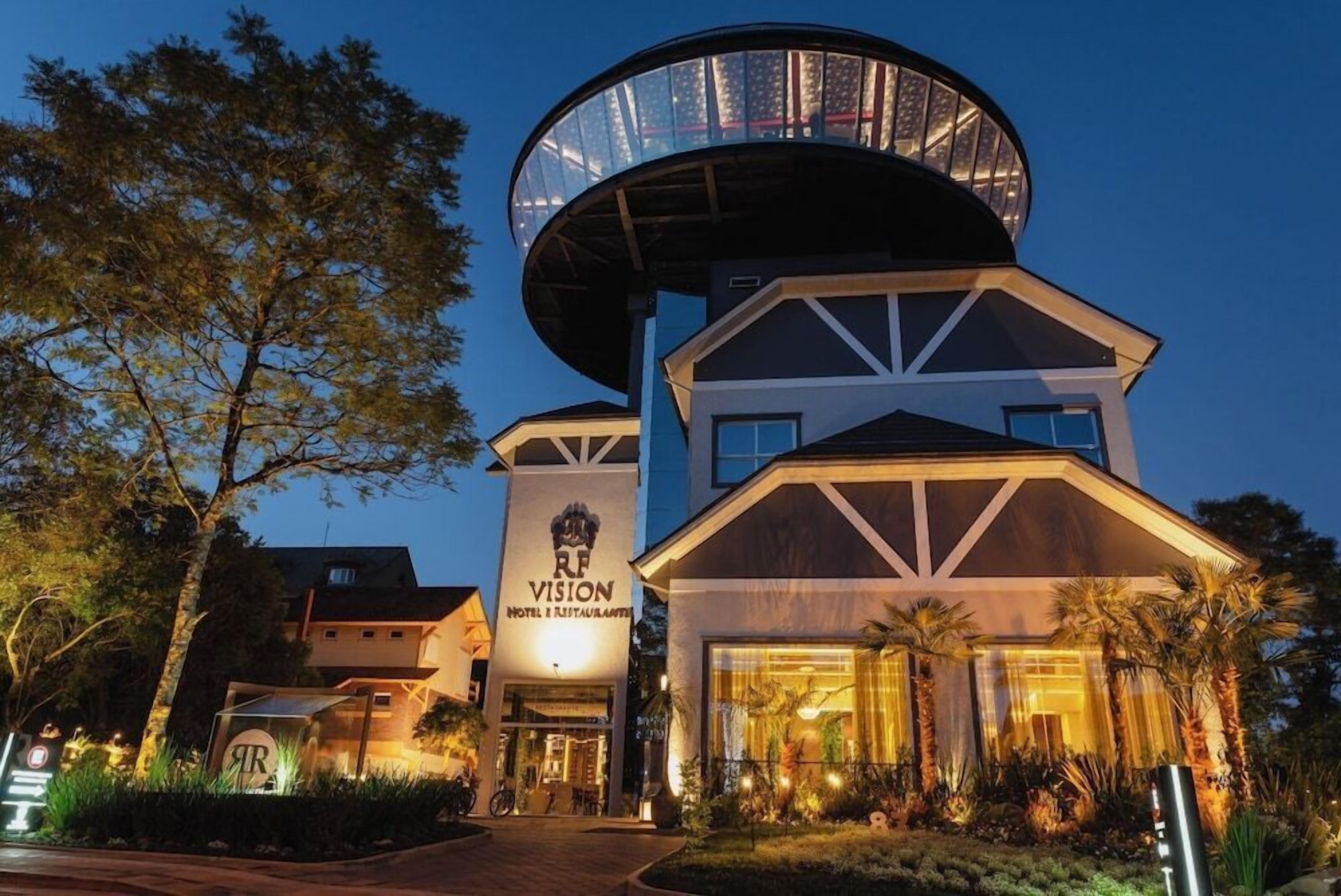 A hotel with a distinctive circular observation tower, a prominent 'RF Vision' sign, and a well-lit entrance.