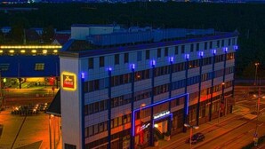 A multi-story hotel with a prominent 'Hotel' sign, a visible entrance, and a parking lot. - Hotel Rhein-ruhr (Bottrop)