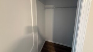 A narrow hallway with a closet and a wooden floor. - Excellent 3-bedroom house with AC in cool Louisville neighborhood (Louisville)