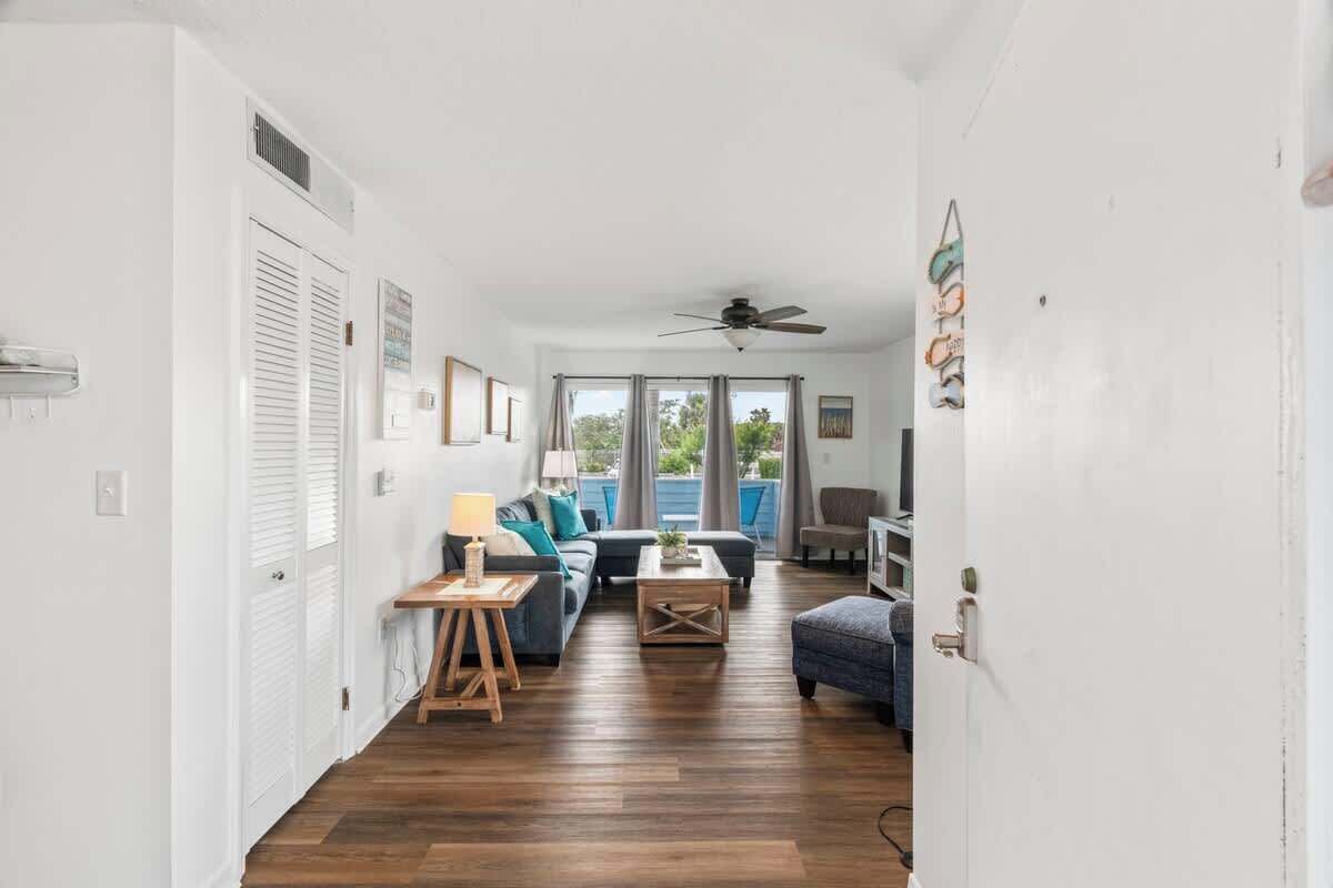 A compact living space with a sofa, coffee table, and a ceiling fan.