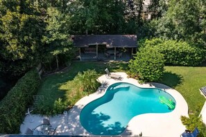 A residential property with a swimming pool, a covered patio, and a well-maintained lawn. - Coastal Lane - Entire (Jacksonville)