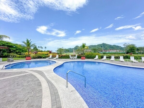A swimming pool with lounge chairs and a view of a mountainous landscape. - Del Mar Golf View Retreat at Los Buenos Resort (Herradura)