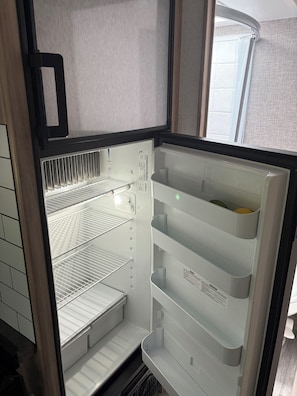 A refrigerator with multiple shelves and a freezer compartment.