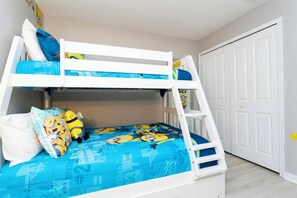 A bunk bed with a blue mattress and pillows, a white ladder, and a white door in the background. - Private Pool | No Carpet | Walk to Walmart | Spotless (Kissimmee)