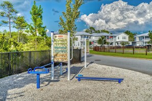 A playground with exercise equipment and a sign detailing a fitness routine. - The Emerald at 30A: Heated Pool, Golf Cart, Bikes (Santa Rosa Beach)
