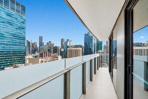 A balcony with a city view, glass railings, and a clear sky. - Sheraton Little Collins by Ready Set Stay (Melbourne)