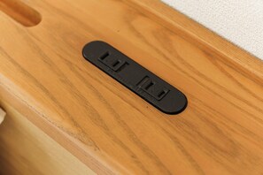 A wooden surface with a black rectangular object featuring two slots and a button. - SERENE Osaka | 2 Minutes from Nipponbashi Station | 6F-606 | 35 ㎡, 2BR (osaka)