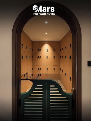 A Mars ReSpawn Hotel men's locker room with a curved entrance and multiple lockers.