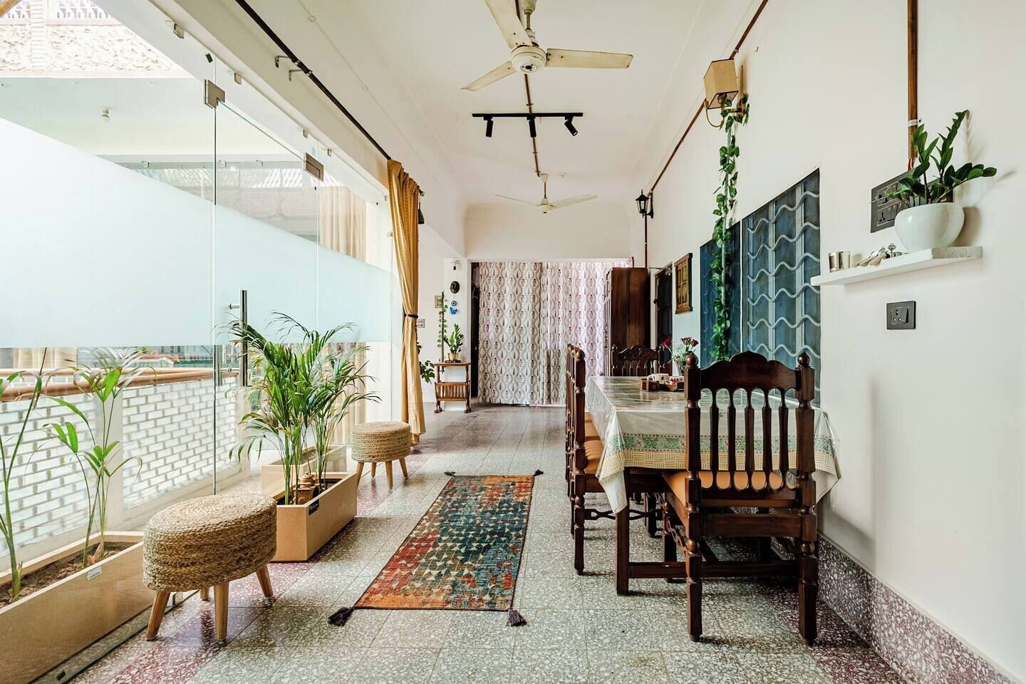 A dining area with a table, chairs, and a patterned rug.
