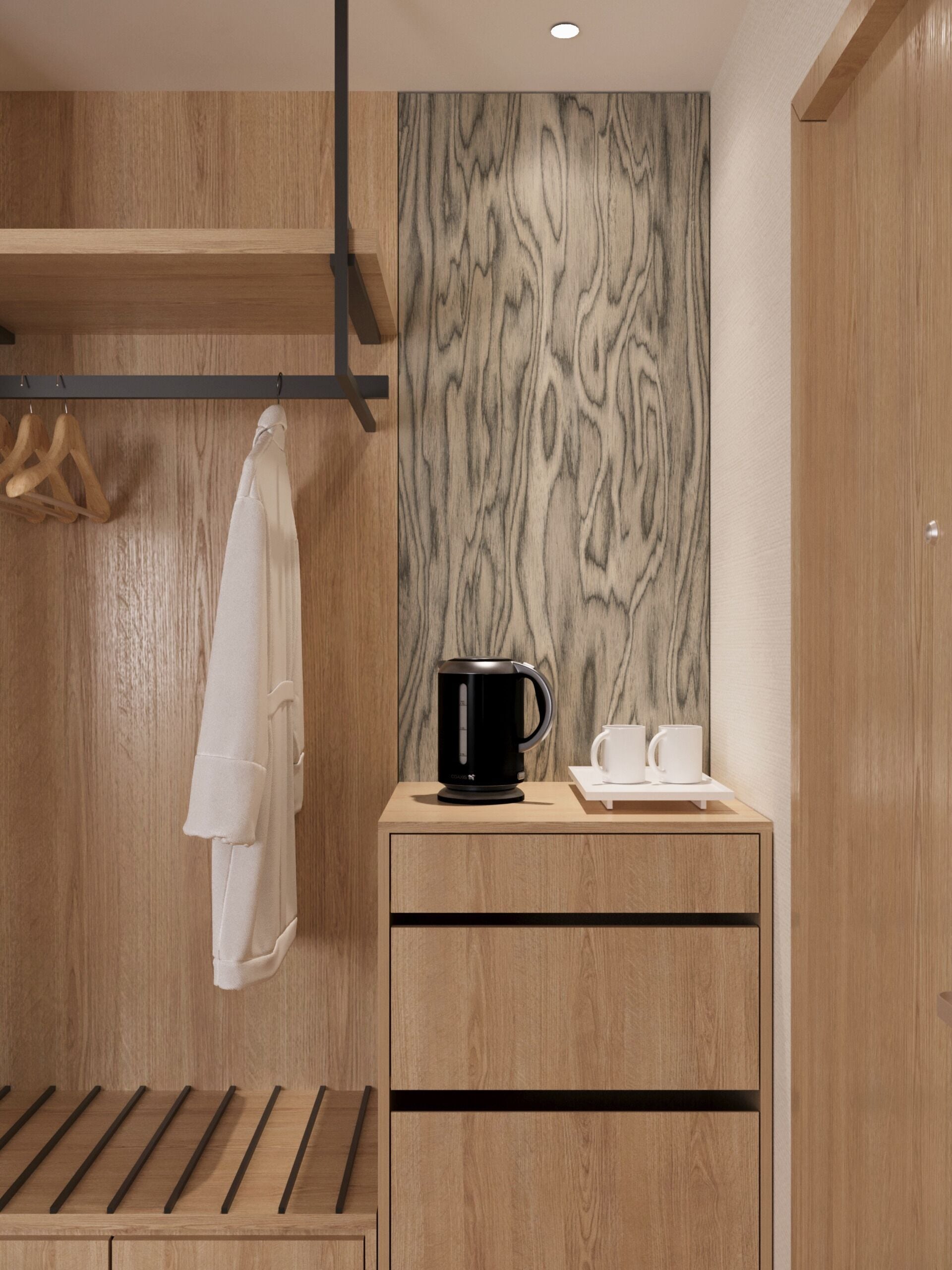 A wooden cabinet with a black coffee maker and two white cups on a tray.