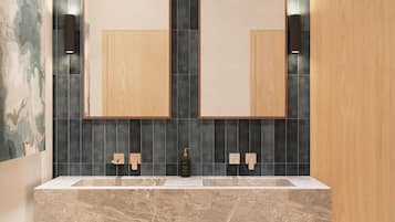 A modern bathroom with a double vanity, dark tiled backsplash, and wooden cabinetry.