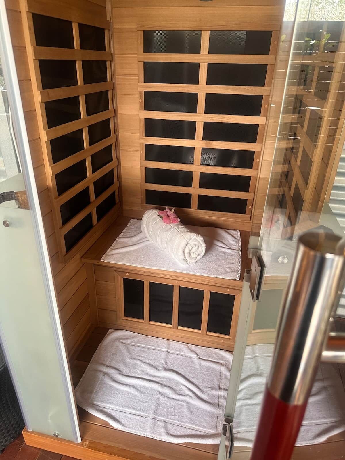 A sauna with wooden walls and a bench.