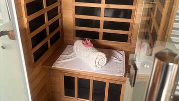 A sauna with wooden walls and a bench.